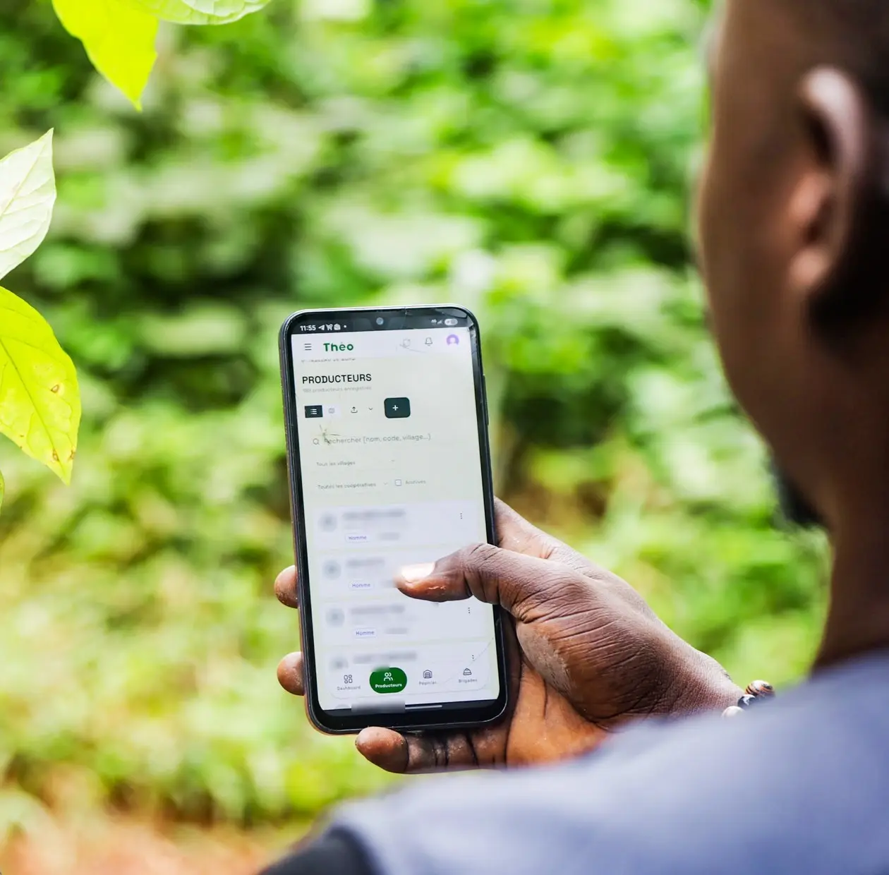 Technician checking the list of farmers in the Theo app on their phone